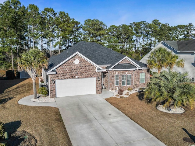 view of front of home featuring a garage and a front yard