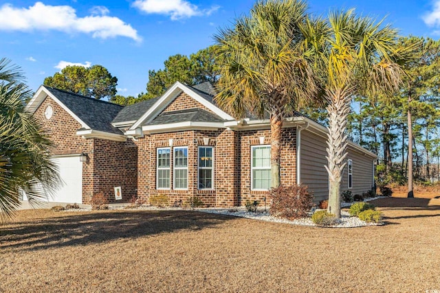 view of front of property with a garage and a front lawn