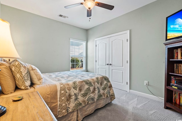 carpeted bedroom featuring a closet and ceiling fan