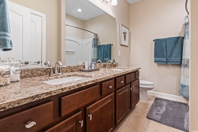 bathroom with vanity, toilet, curtained shower, and tile patterned flooring