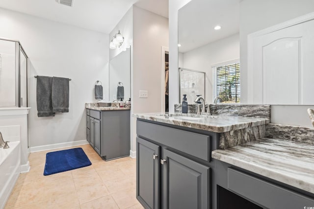 bathroom with tile patterned flooring, vanity, and shower with separate bathtub