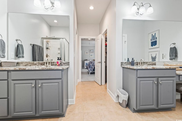 bathroom with tile patterned flooring, vanity, and an enclosed shower