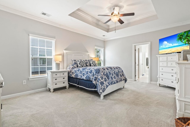 bedroom with light carpet, ornamental molding, a raised ceiling, and ceiling fan