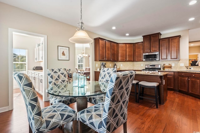 dining space with dark hardwood / wood-style flooring