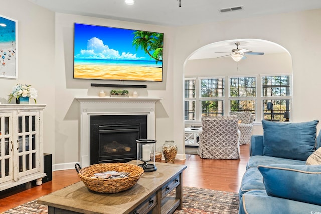 living room featuring wood-type flooring and ceiling fan