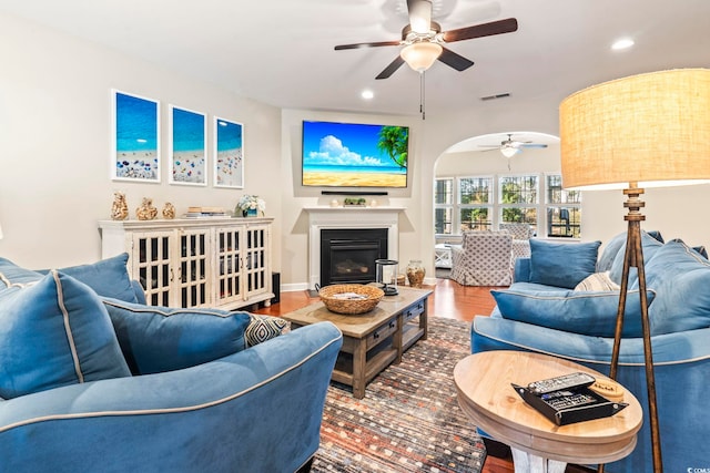 living room featuring hardwood / wood-style floors and ceiling fan