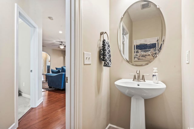 bathroom featuring sink, hardwood / wood-style flooring, and ceiling fan