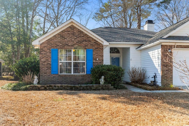 view of front of property featuring a garage and a front yard