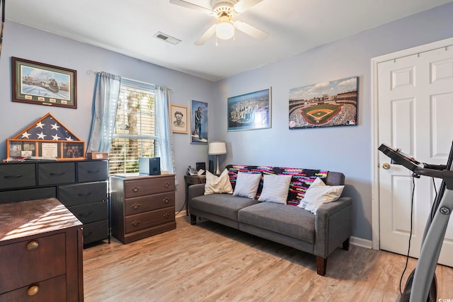 living room featuring ceiling fan and light wood-type flooring