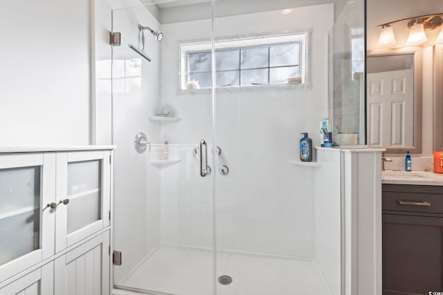 bathroom featuring vanity and a shower with shower door