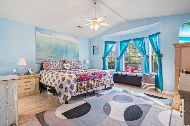 bedroom featuring ceiling fan, lofted ceiling, and light hardwood / wood-style flooring