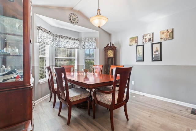 dining area featuring lofted ceiling and hardwood / wood-style flooring