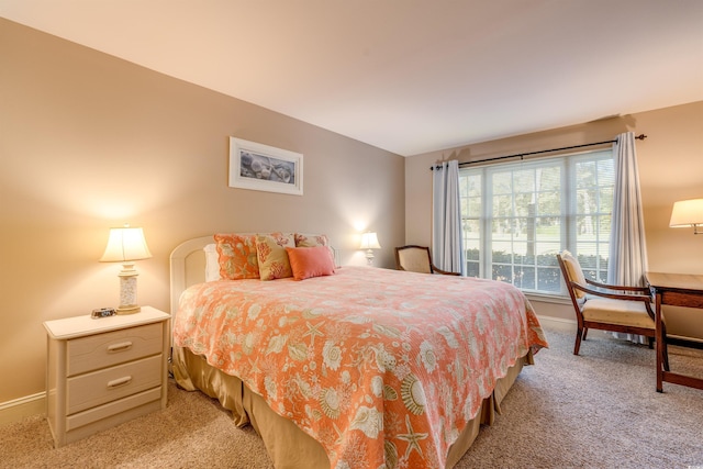 bedroom with light carpet and baseboards