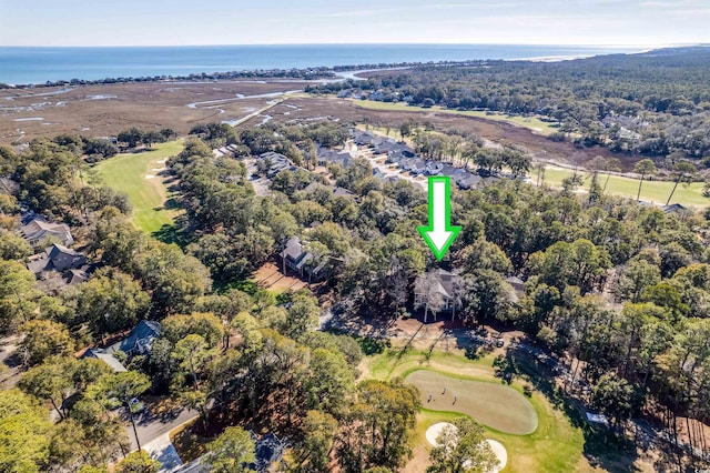 view of property location with a golf course and a large body of water