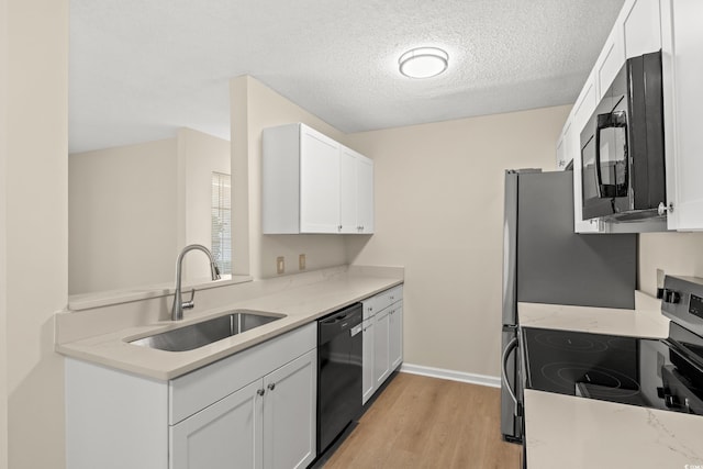 kitchen featuring white cabinetry, light stone countertops, sink, and black appliances