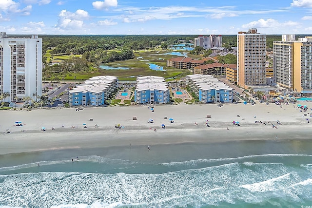 bird's eye view featuring a water view and a beach view