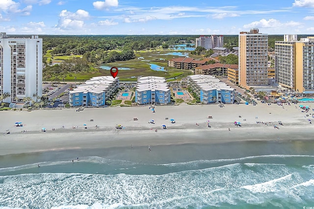 birds eye view of property featuring a view of the beach and a water view