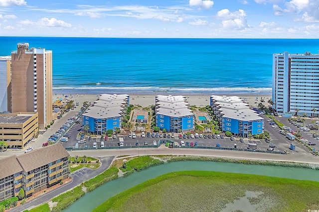 bird's eye view featuring a water view and a beach view