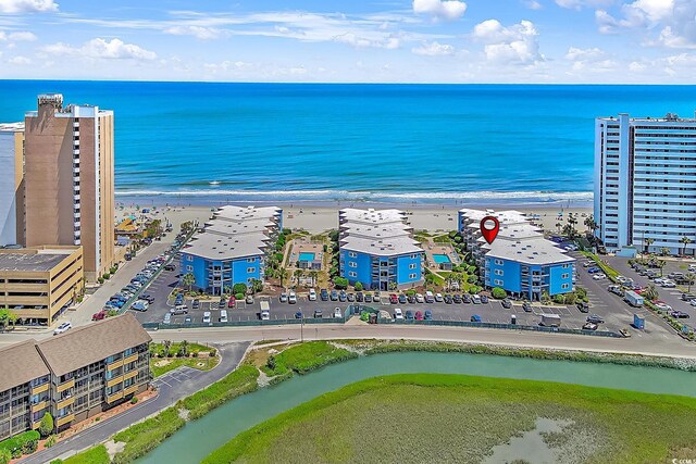 aerial view featuring a view of the beach and a water view