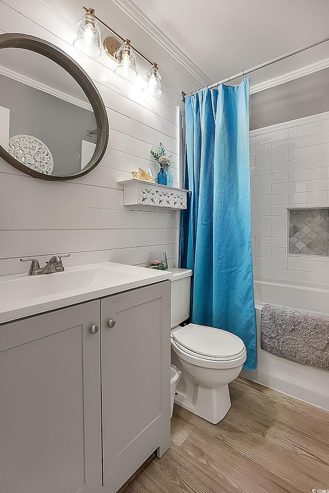 full bathroom with shower / tub combo with curtain, toilet, crown molding, wood-type flooring, and vanity