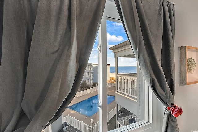 interior space featuring a water view and a view of the beach