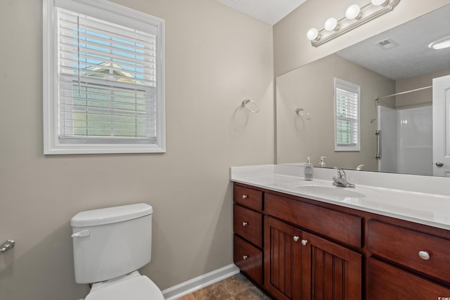 full bathroom featuring visible vents, toilet, baseboards, walk in shower, and vanity