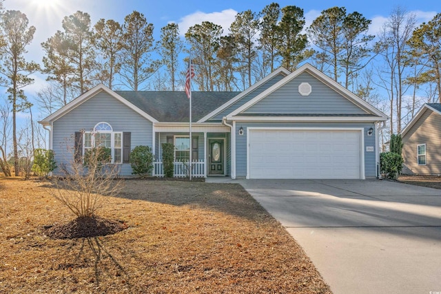 single story home featuring covered porch, concrete driveway, and an attached garage