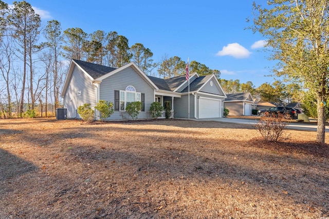 single story home featuring central air condition unit, a garage, and driveway