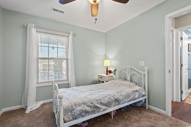 bedroom featuring visible vents, baseboards, carpet, and a ceiling fan