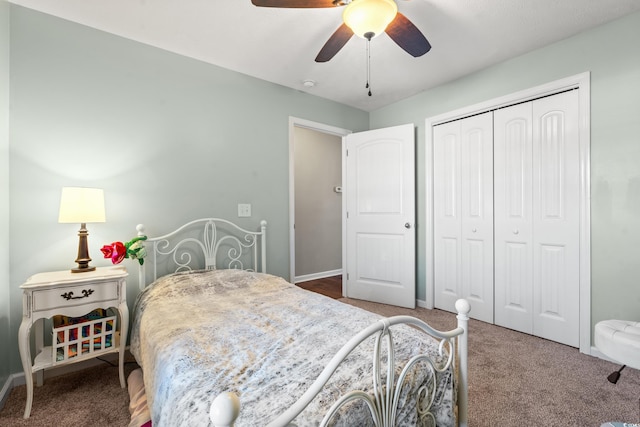 carpeted bedroom featuring a closet, baseboards, and a ceiling fan