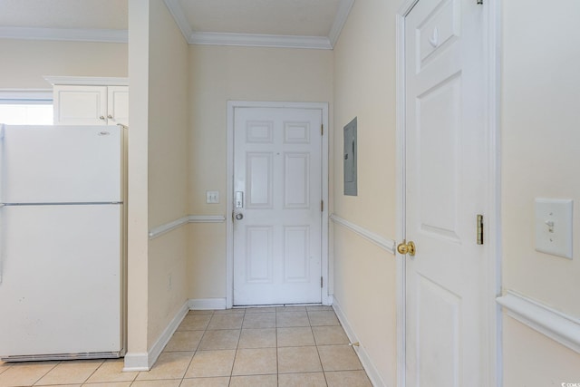 doorway with light tile patterned floors and ornamental molding