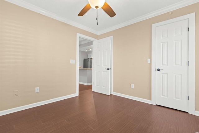 spare room with crown molding, ceiling fan, and dark hardwood / wood-style floors