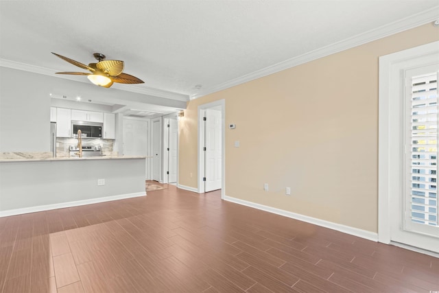 unfurnished living room with dark wood-type flooring, ornamental molding, and ceiling fan