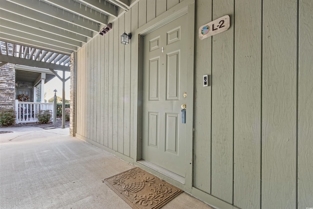 entrance to property with a pergola