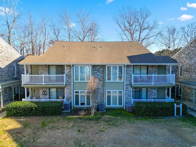 rear view of house featuring a balcony and central air condition unit