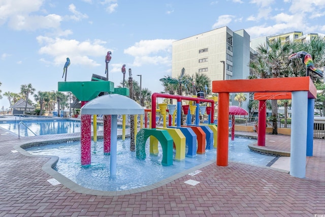 view of jungle gym with a community pool