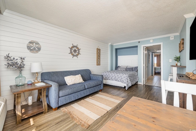 bedroom with crown molding, dark hardwood / wood-style flooring, and a textured ceiling