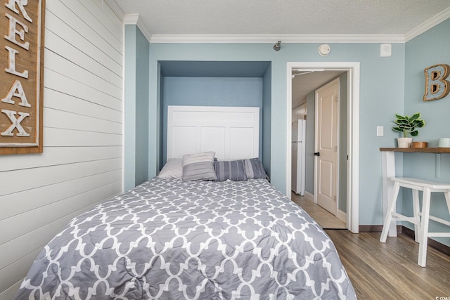 bedroom with hardwood / wood-style flooring, ornamental molding, a textured ceiling, and white refrigerator