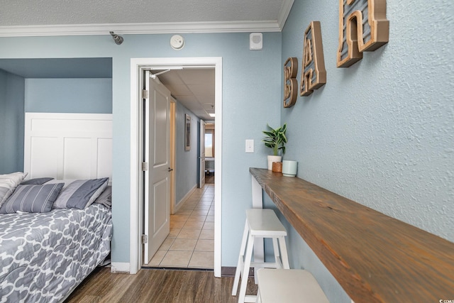 hallway with hardwood / wood-style flooring, crown molding, and a paneled ceiling