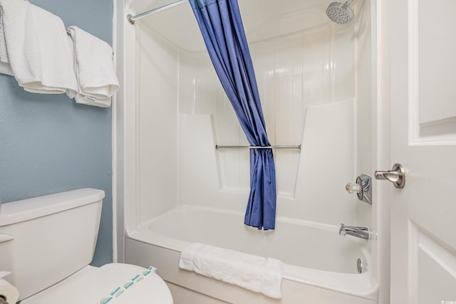 bathroom with shower / bath combination with curtain and toilet