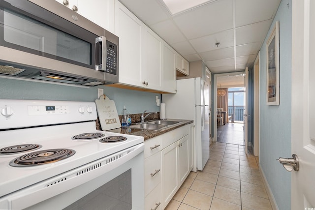 kitchen featuring white cabinetry, sink, white appliances, and a paneled ceiling