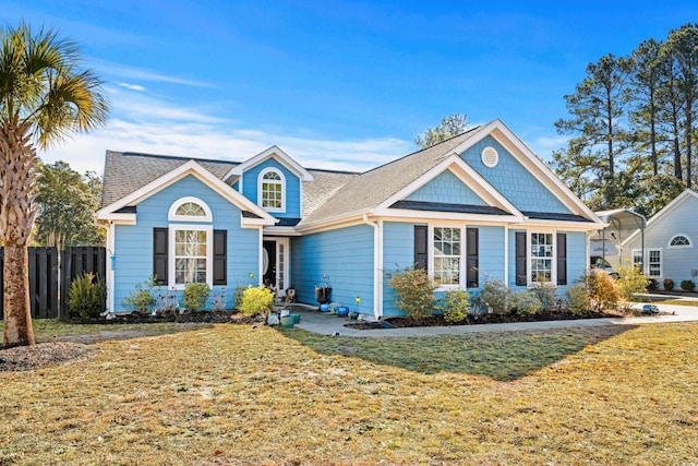 view of front of home with a front yard and a carport