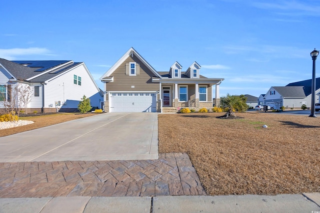 view of front facade with a porch, a garage, and a front yard