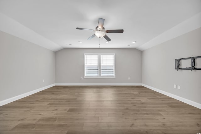 spare room featuring ceiling fan, vaulted ceiling, and light hardwood / wood-style flooring