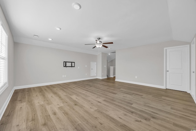 unfurnished living room featuring light hardwood / wood-style flooring, ceiling fan, and vaulted ceiling