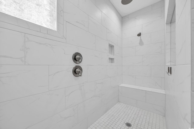 bathroom with tiled shower