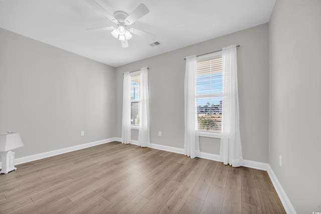 empty room featuring ceiling fan and light hardwood / wood-style floors