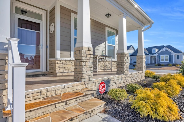 view of exterior entry with covered porch