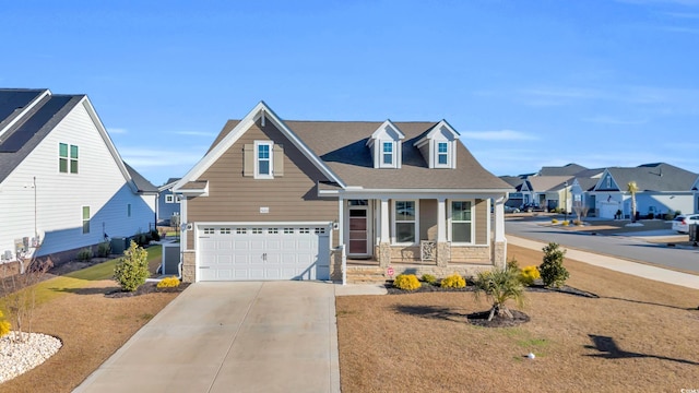 view of front of property with a garage, a front yard, and covered porch