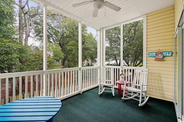 unfurnished sunroom featuring ceiling fan